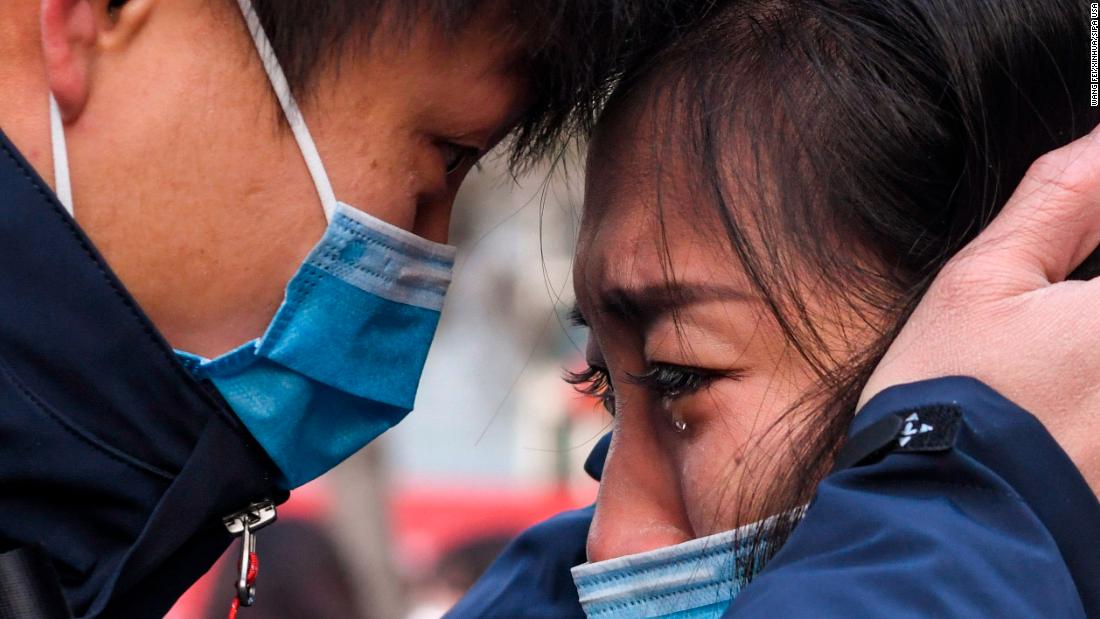 Lyu Jun, left, a member of a medical team leaving for Wuhan, says goodbye to a loved one in Urumqi, China, on January 28.