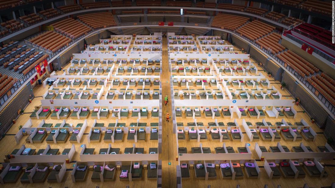 Beds are made in the Wuhan Sports Center, which has been converted into a temporary hospital.